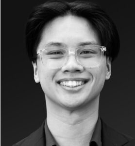 Tien Tang Black and white headshot of a man with dark hair and glasses.